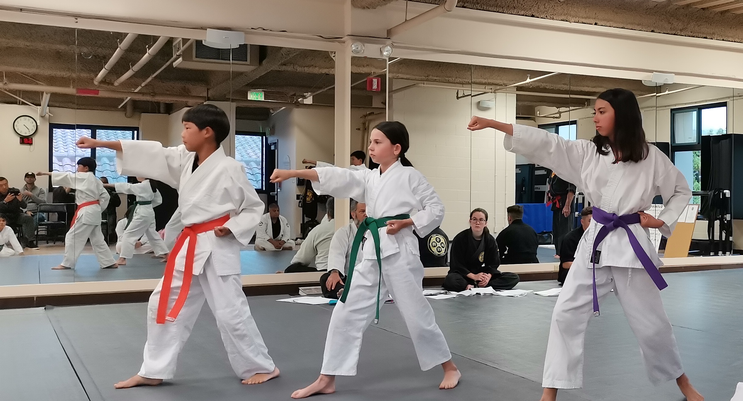 Students practicing martial arts techniques in the dojo